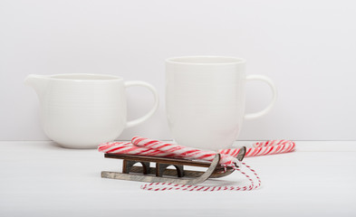 Christmas Candy Cane On Wooden Sledge. White Painted Wood Backgr