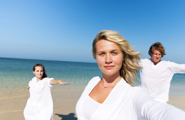 Obraz premium People Performing Yoga on the Beach