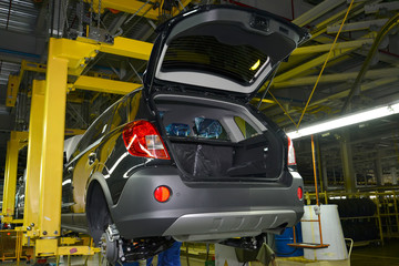 The car in the suspended look on the assembly conveyor of automo