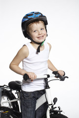 Obraz premium Portrait of young boy on bicycle, studio