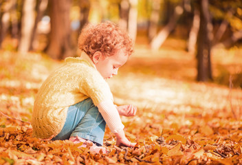 girl playing at fallen leafs