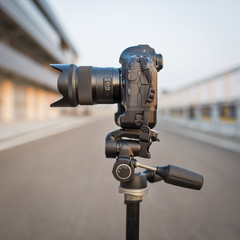 Camera on tripod isolated shot outdoors.