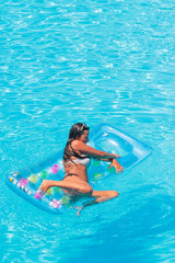 Fototapeta na wymiar Relaxing in a swimming pool