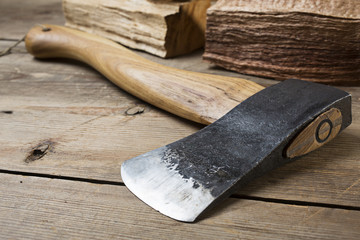 Wooden handle axe lying on wooden table