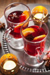 glass of mulled wine with orange and spices, christmas decoratio