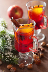 glass of mulled wine with orange and spices, christmas decoratio