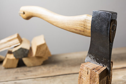 Old wooden handle axe in a block of wood