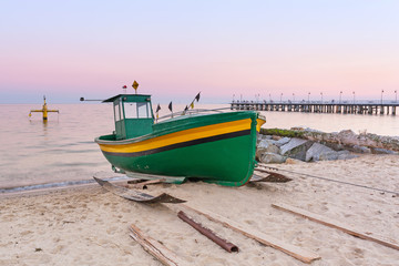 Fototapeta premium Baltic beach with fishing boat at sunset, Poland