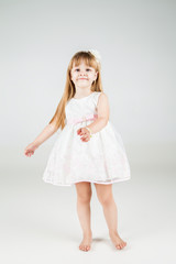 Little fashion girl in beautiful dress posing