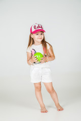 Fototapeta na wymiar Little fashion girl in sport wear posing
