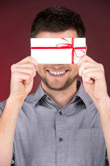 Present gift in hands of smiling man.