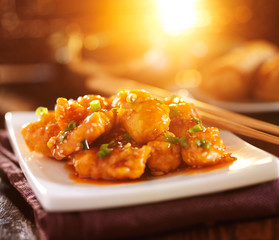 colorful chinese sesame chicken dish with lens flare