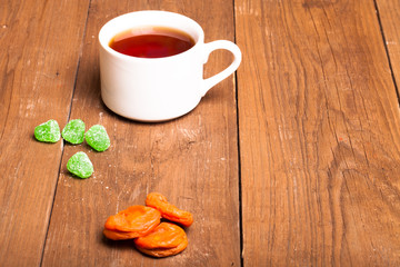 A cup of tea on an old wooden table. small depth of field