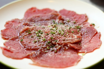 sliced pork on white plate