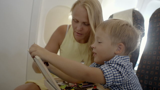 Mother and son playing game in the plane