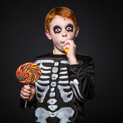 Happy young red hair boy with halloween costume