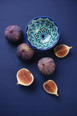 Above view of fig fruits over dark blue wooden surface