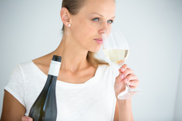 Gorgeous young woman with a glass of wine