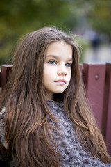 Beautifal little girl in the autumn park