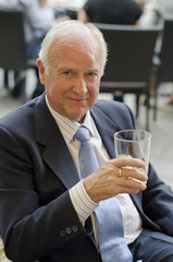 Senior man looking atthe view with alcohol glass