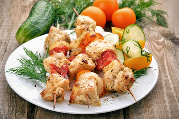 Chicken shish kebab on wooden table