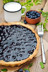 Blueberry pie on rustic wooden table