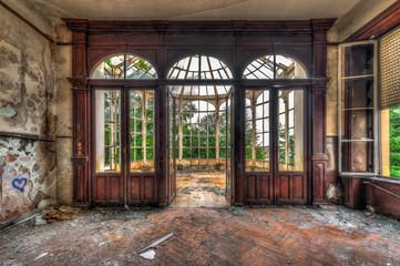 Abandoned room with view through beautiful broken conservatory