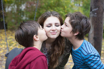 Fototapeta premium two boys kissing a teenage girl
