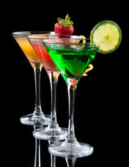 Three cocktails cosmopolitan cocktails decorated with citrus lem