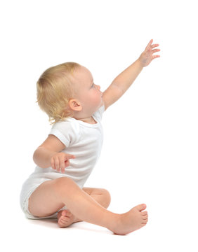 Infant child baby toddler sitting raise hand up pointing finger