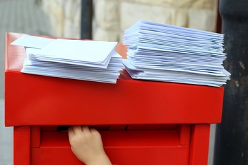 children's hand putting lettersin mailbox