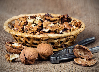 Whole and chopped walnuts on sacking