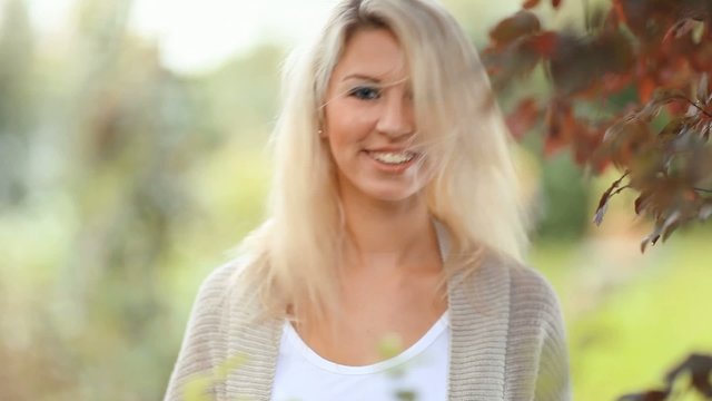 Beautiful, blonde young woman in the garden