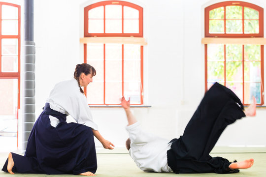 Aikido teacher and student training throwing and falling