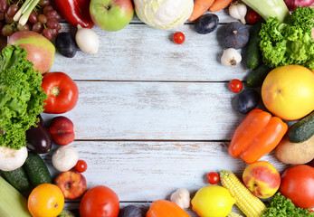 Fresh organic fruits and vegetables on wooden background