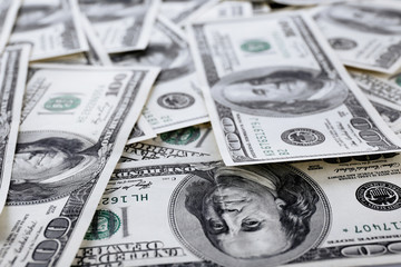 Lot of one hundred dollar bills close-up background