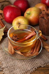 Composition of  apple cider with cinnamon sticks, fresh apples