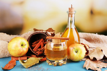 Composition of apple cider with cinnamon sticks, fresh apples