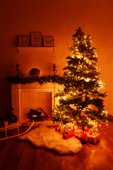 Christmas tree near fireplace in room