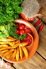 Homemade fried potato on plate on wooden background