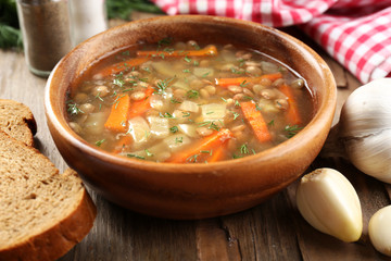 Delicious lentil soup on table close-up