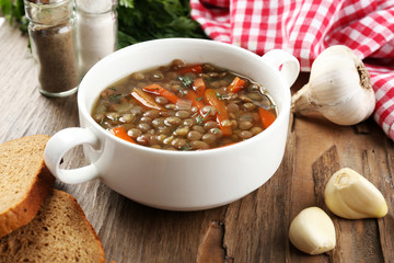 Delicious lentil soup on table close-up