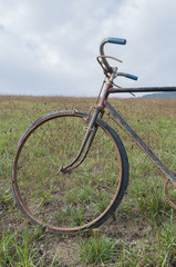 Fototapeta na wymiar Antique or retro oxidized bicycle outside