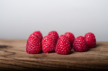 Fresh organic raspberry on wood