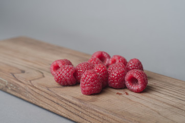 Fresh organic raspberry on wood