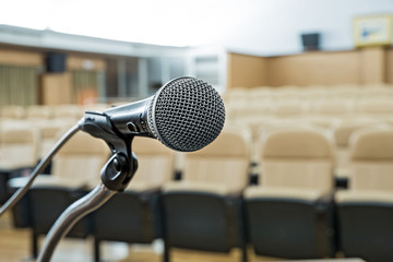 before a conference, the microphones in front of empty chairs.