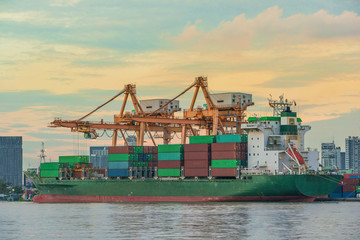 Container Cargo freight ship with working crane loading bridge i