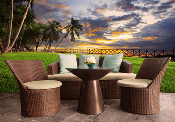 rattan chairs in outdoor terrace living room against beautiful s
