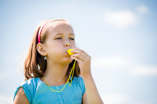 Child Blowing Whistle