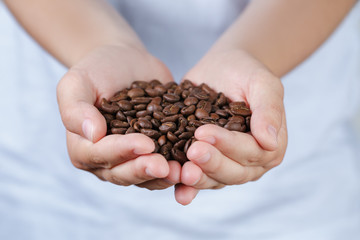 female teen hands hold coffee beans
